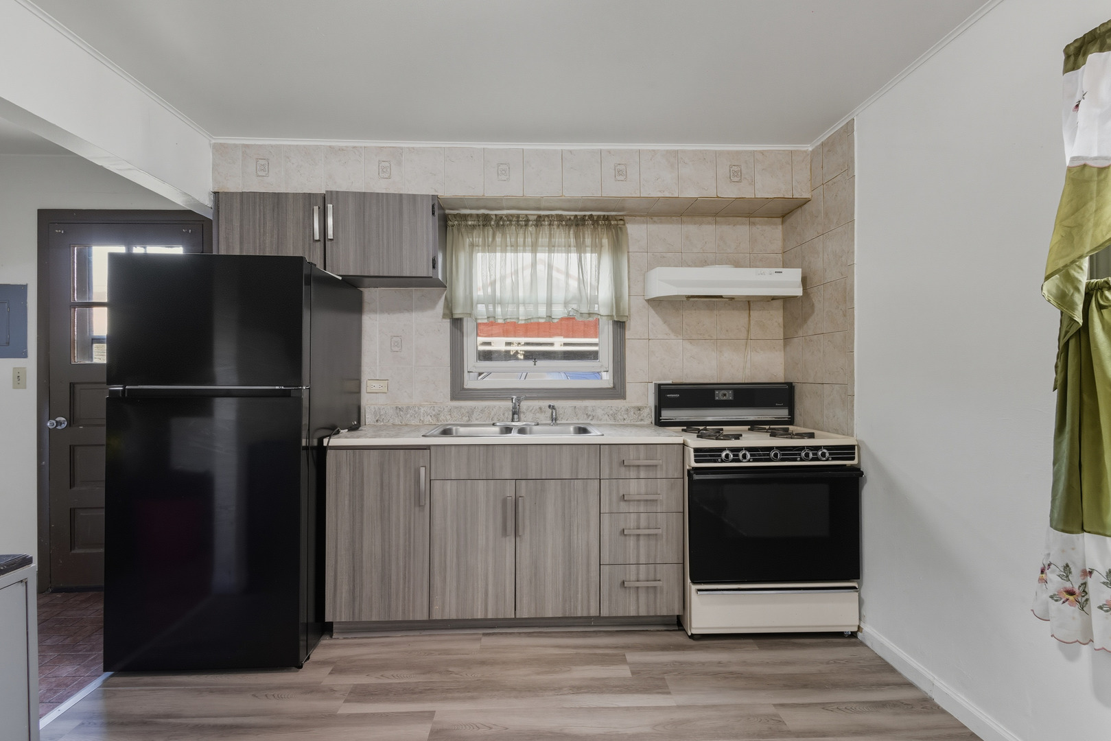 11013 Menard Avenue Chicago Ridge, IL 60415 - Photo 7 of 40 a kitchen with a refrigerator stove and sink