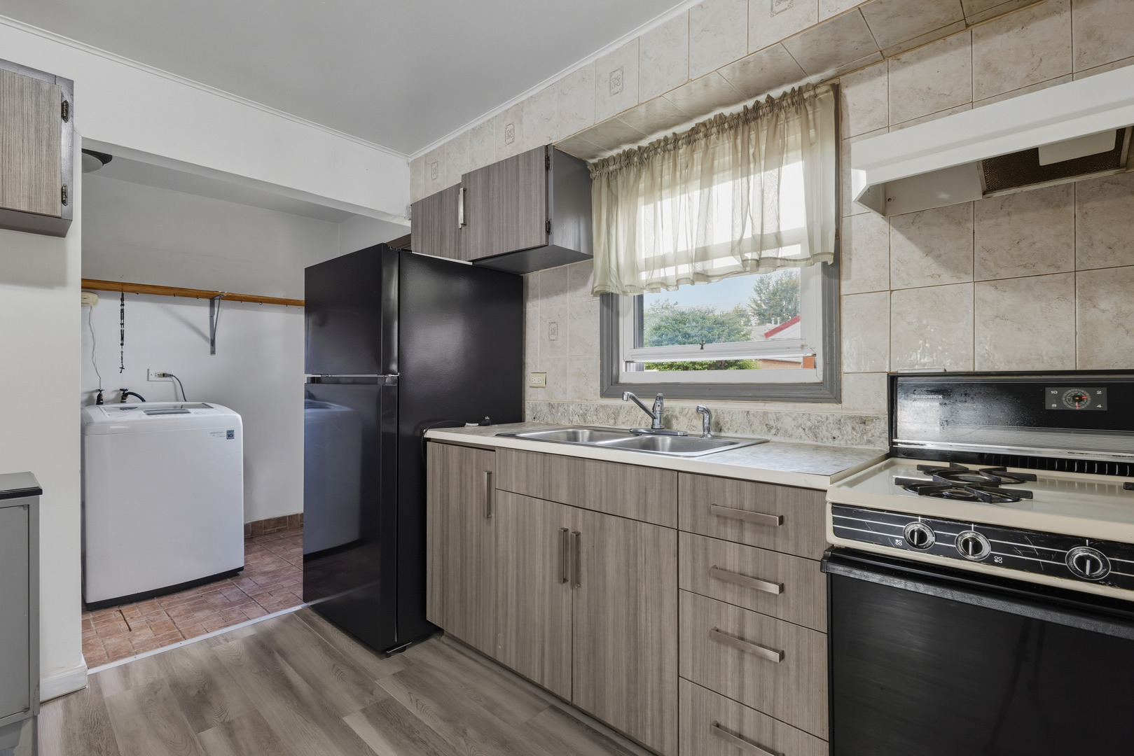 11013 Menard Avenue Chicago Ridge, IL 60415 - Photo 8 of 40 a kitchen with stainless steel appliances a sink cabinets and a window