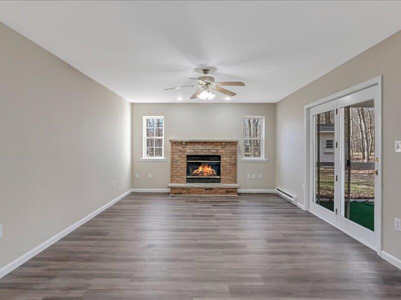 1135 Juno Drive Effort, PA 18330 - Photo 11 of 68 a view of an empty room with wooden floor fireplace and a window