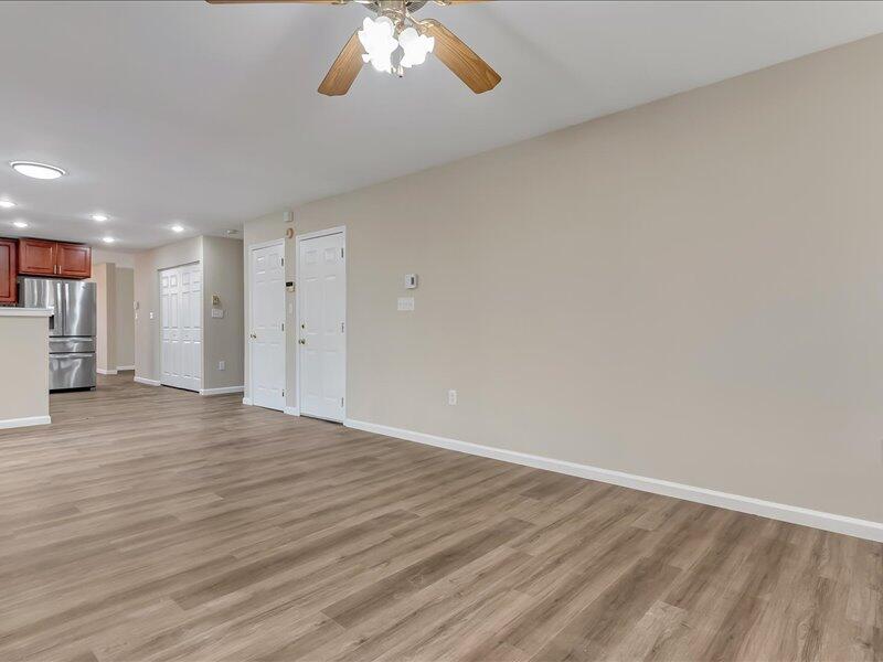 1135 Juno Drive Effort, PA 18330 - Photo 15 of 68 a view of an empty room with wooden floor and a chandelier