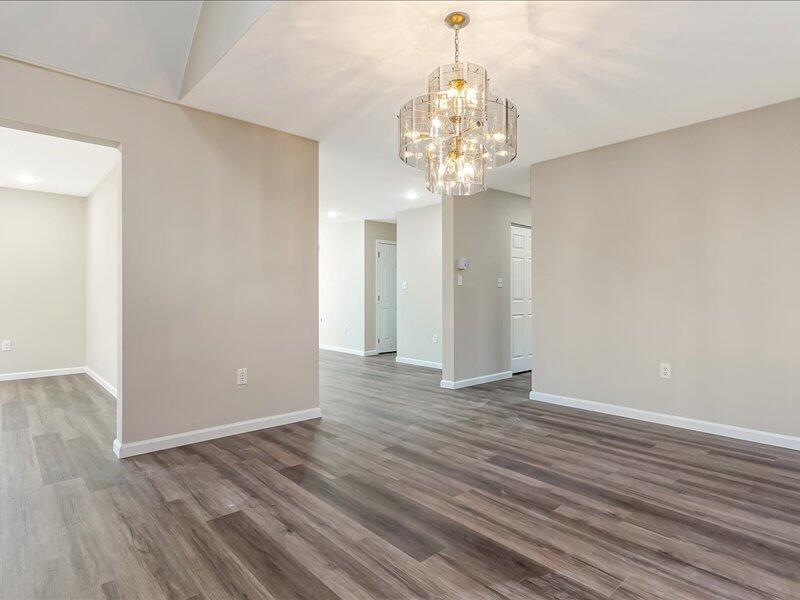 1135 Juno Drive Effort, PA 18330 - Photo 21 of 68 a view of an empty room with wooden floor and chandelier