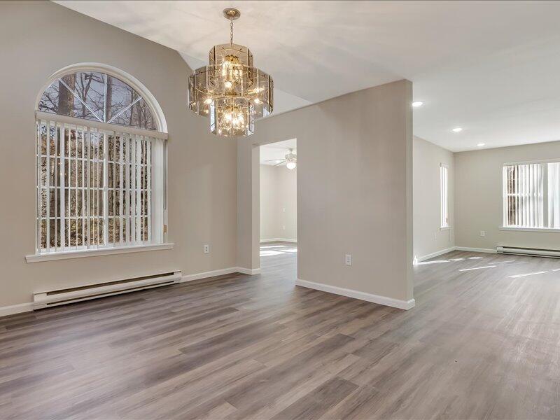 1135 Juno Drive Effort, PA 18330 - Photo 22 of 68 an empty room with wooden floor chandelier and windows