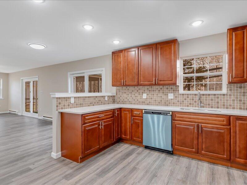 1135 Juno Drive Effort, PA 18330 - Photo 27 of 68 a kitchen with stainless steel appliances granite countertop wooden cabinets a sink and dishwasher with wooden floor
