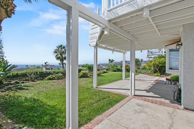 a view of a garden with a table and chairs