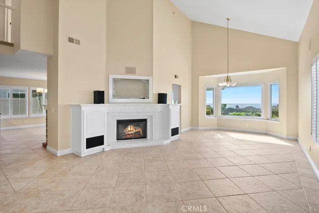 a view of a livingroom with a fireplace and window