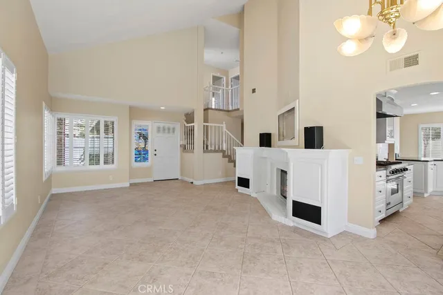 a view of white kitchen with white cabinets and wooden floor