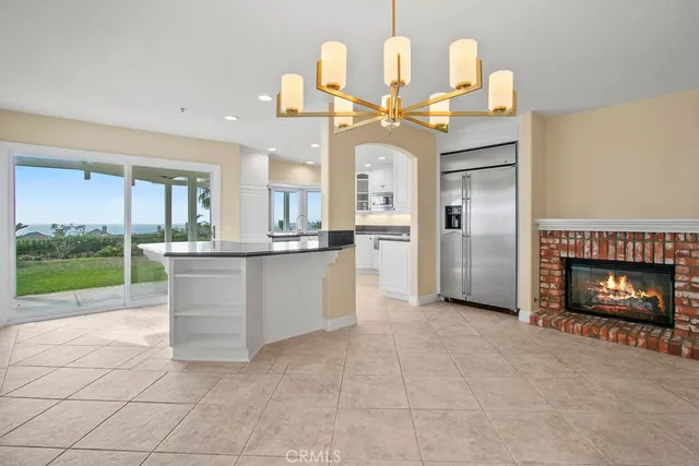 a kitchen with granite countertop a stove and a white cabinets