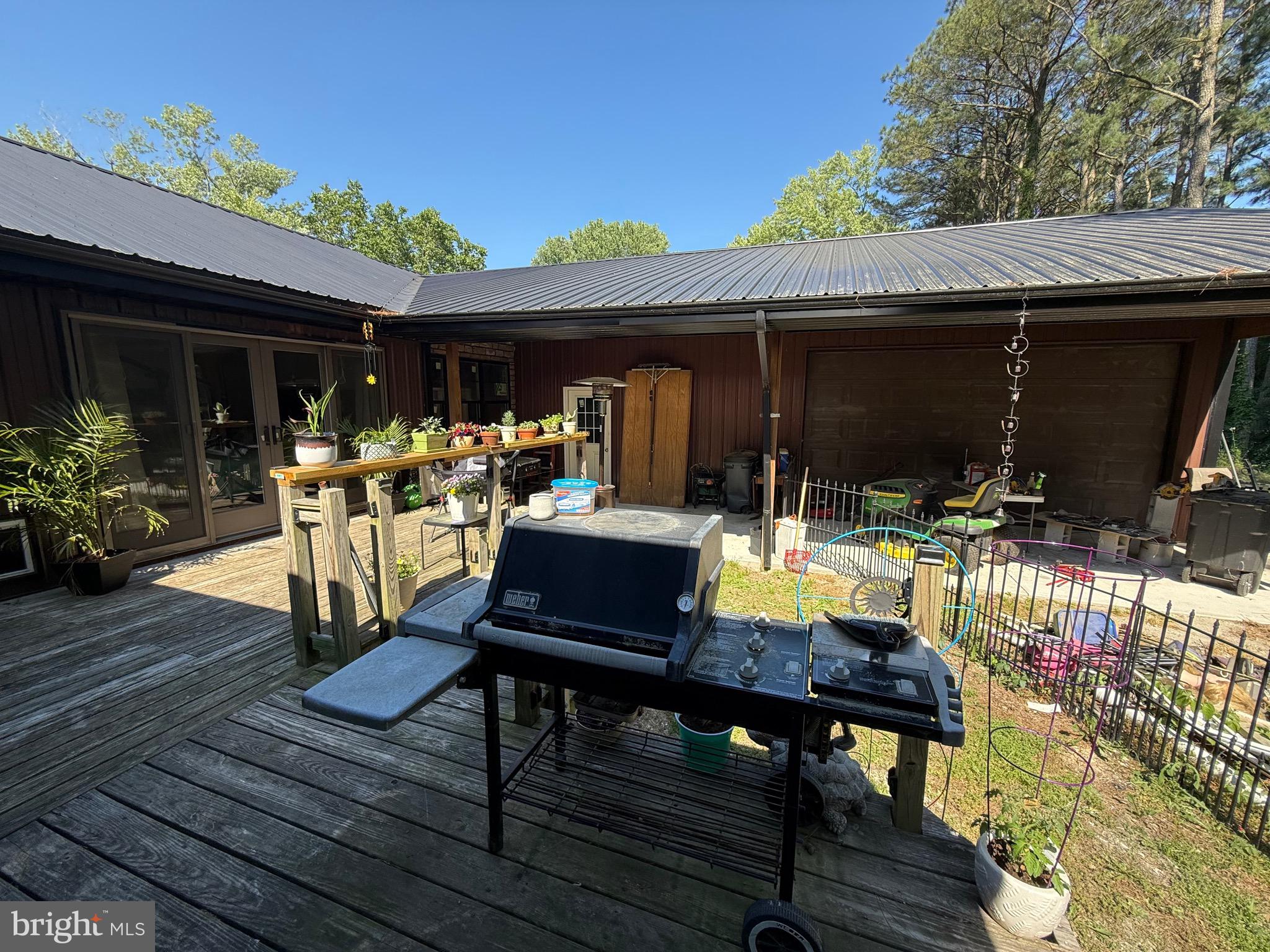 1214 Johnson Road Salisbury, MD 21804 - Photo 50 of 59 a view of a patio with table and chairs with wooden floor and fence