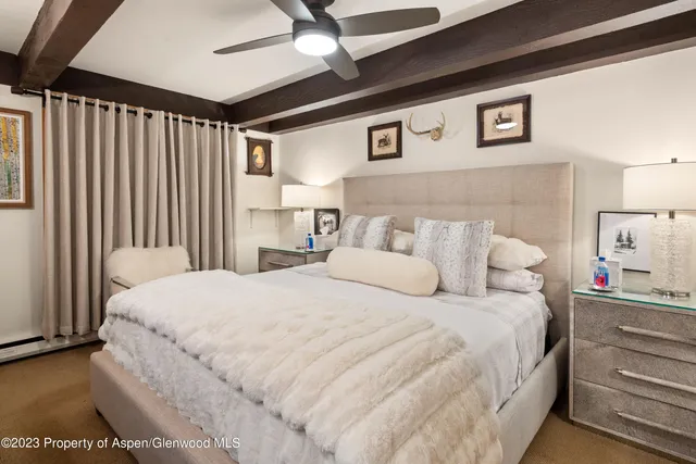 a large bed sitting in a bedroom next to a cabinet