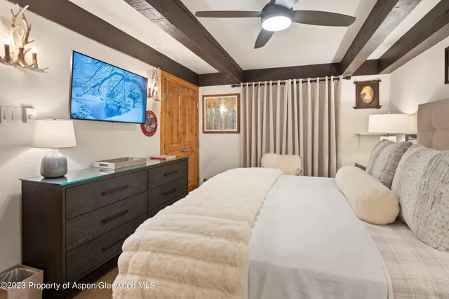 a spacious bedroom with a bed and a large window