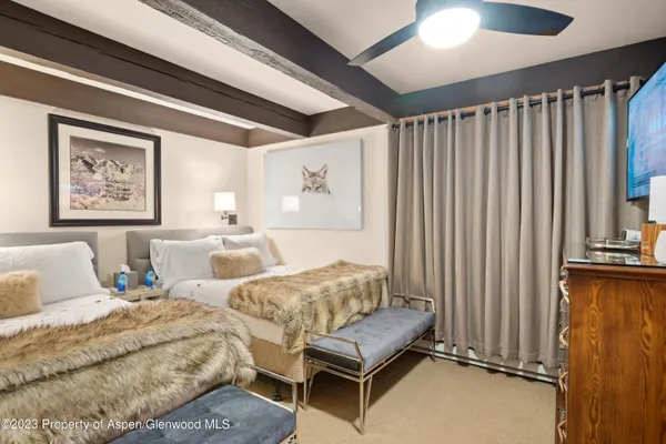 a bedroom with furniture and a large mirror