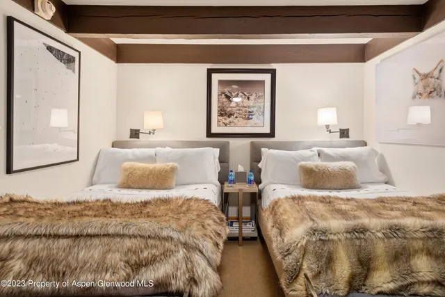 a bedroom with double bed and a window