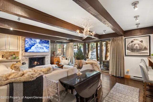 a living room with fireplace furniture and a large window