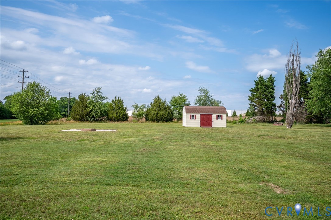 5280 West Quaker Road Disputanta, VA 23875 - Photo 17 of 33 a front view of a house with a yard