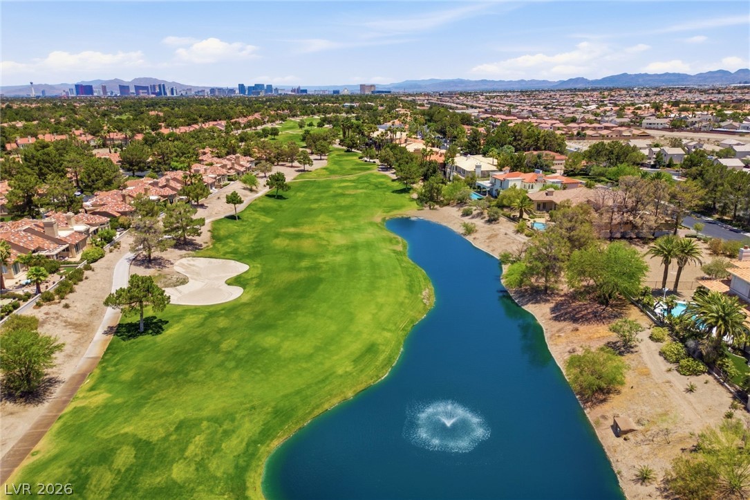20 Innisbrook Avenue Las Vegas, NV 89113 - Photo 16 of 39 Aerial view of a sprawling golf course community, featuring vibrant green fairways alongside a serene lake.