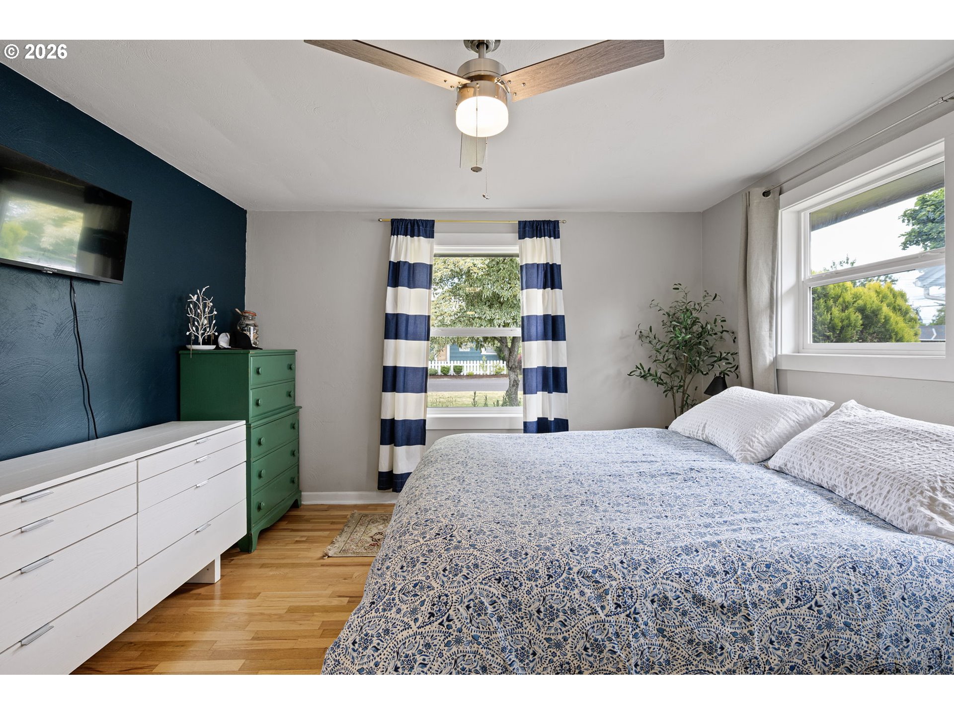 765 Louis Street Eugene, OR 97402 - Photo 22 of 45 a bedroom with a large bed and a chandelier