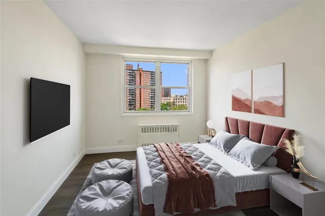 a bedroom with a bed and a flat screen tv