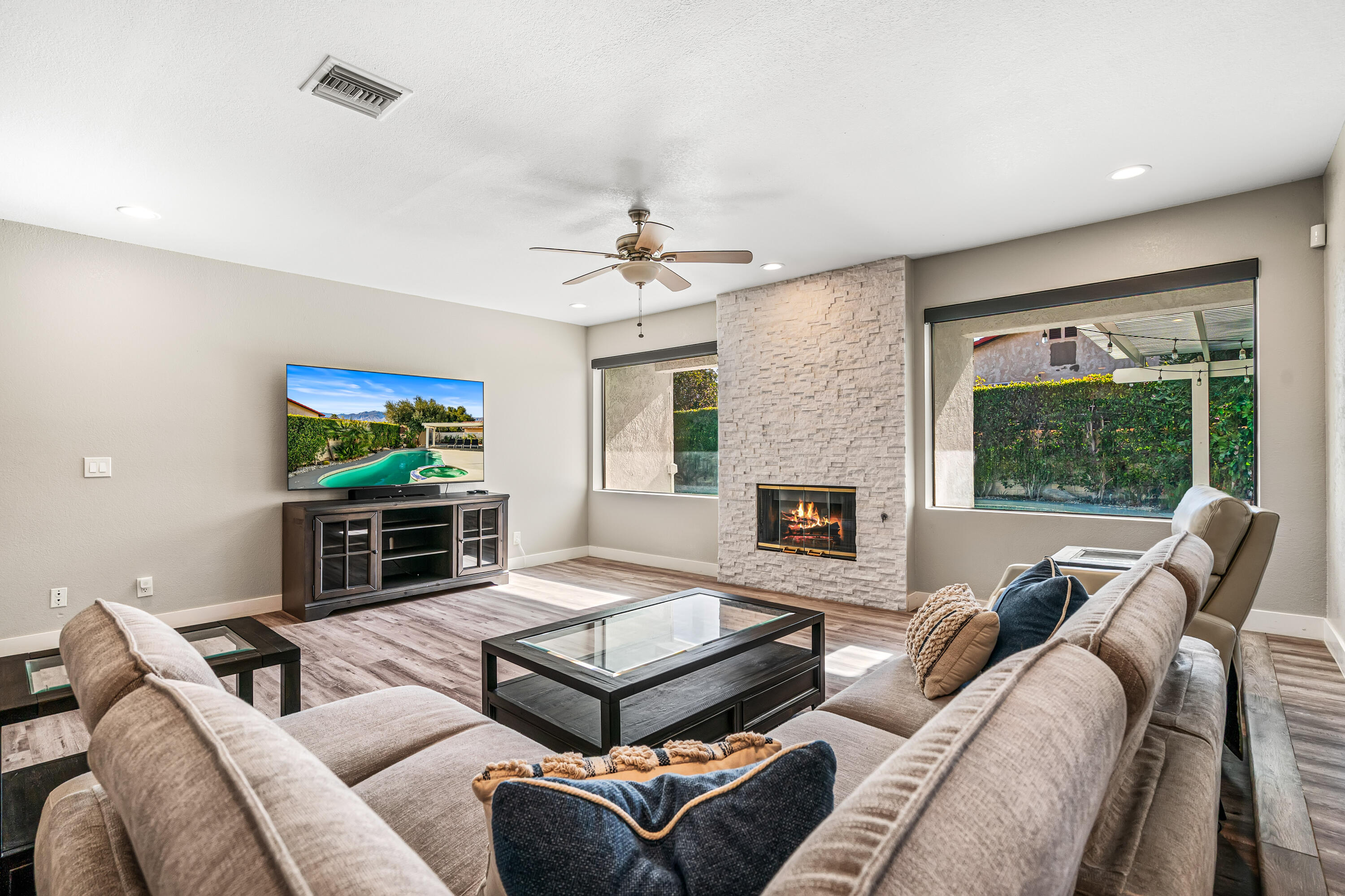 67265 Rango Road Cathedral City, CA 92234 - Photo 11 of 49 a living room with furniture a fireplace and a flat screen tv