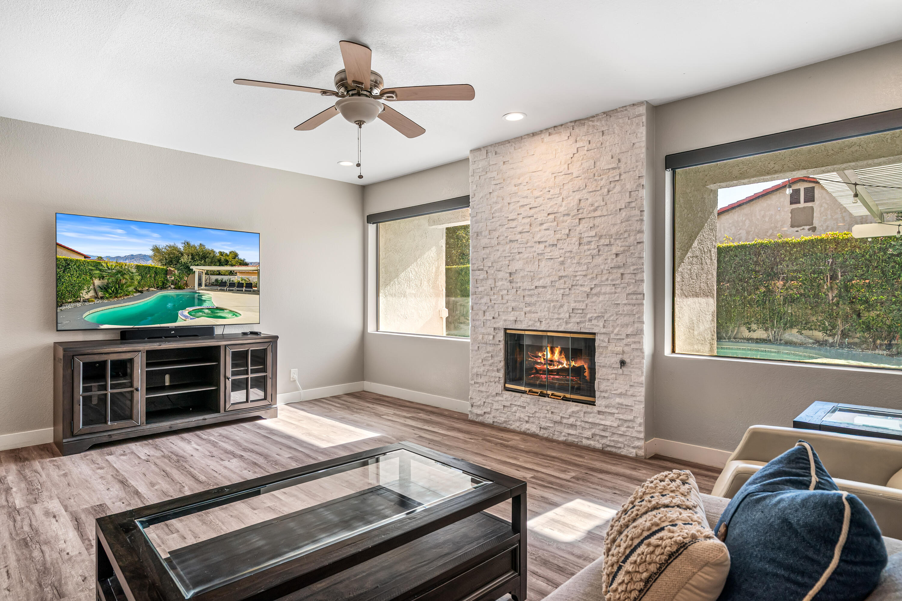 67265 Rango Road Cathedral City, CA 92234 - Photo 12 of 49 a living room with furniture a flat screen tv and a fireplace