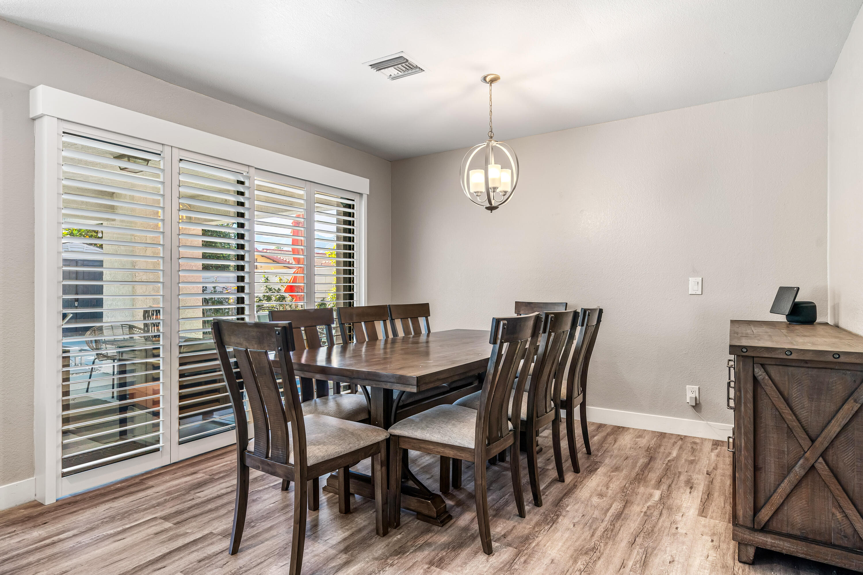 67265 Rango Road Cathedral City, CA 92234 - Photo 16 of 49 a view of a dining room with furniture wooden floor and chandelier