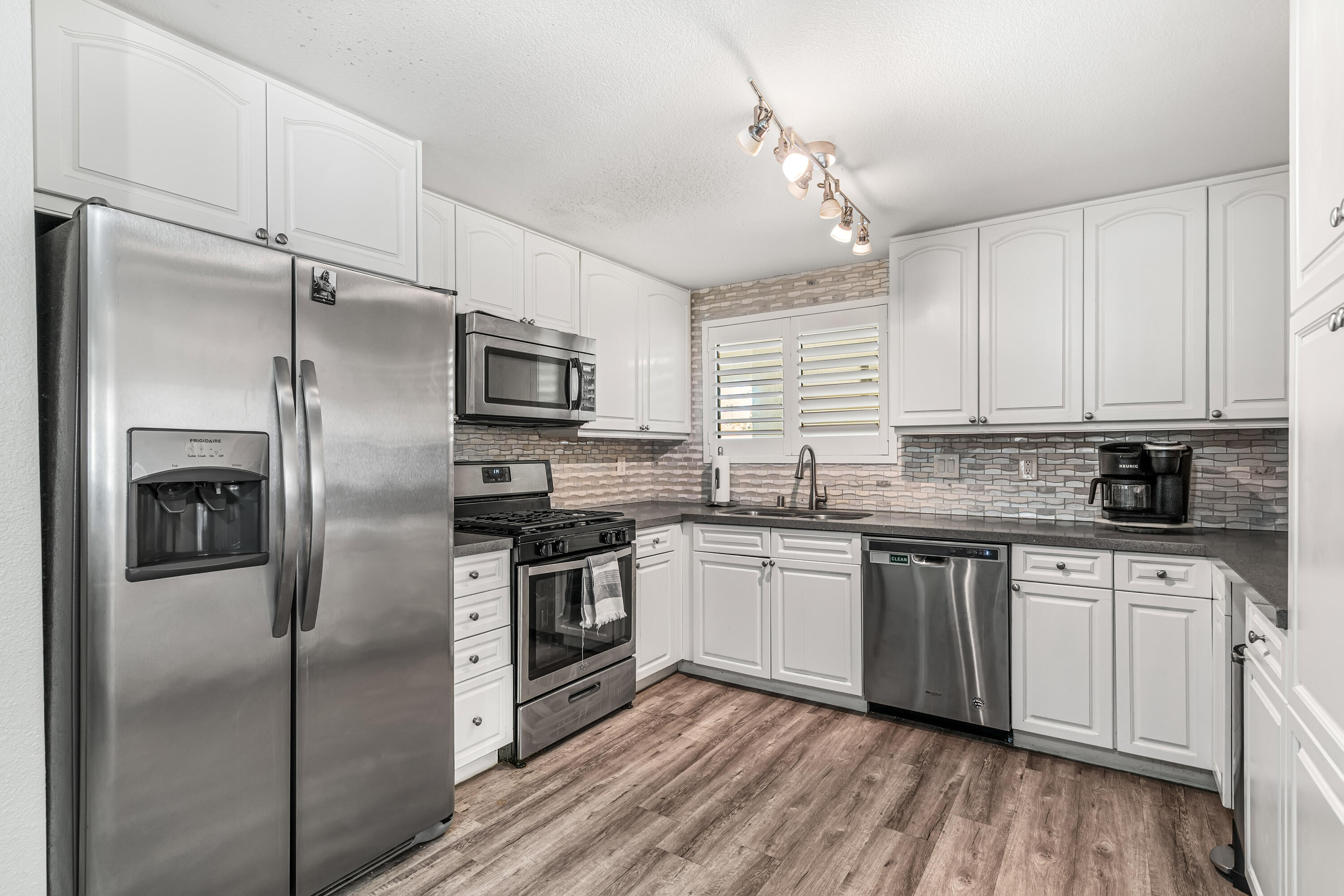 67265 Rango Road Cathedral City, CA 92234 - Photo 18 of 49 a kitchen with stainless steel appliances cabinets a refrigerator and a stove top oven
