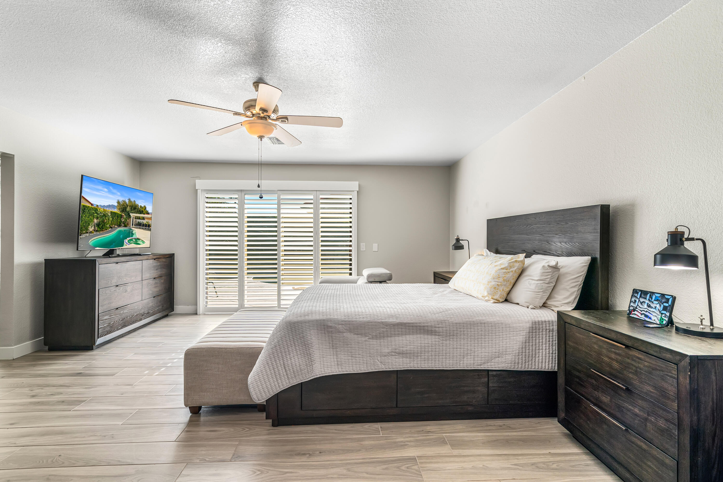 67265 Rango Road Cathedral City, CA 92234 - Photo 25 of 49 a bedroom with a bed and a chandelier