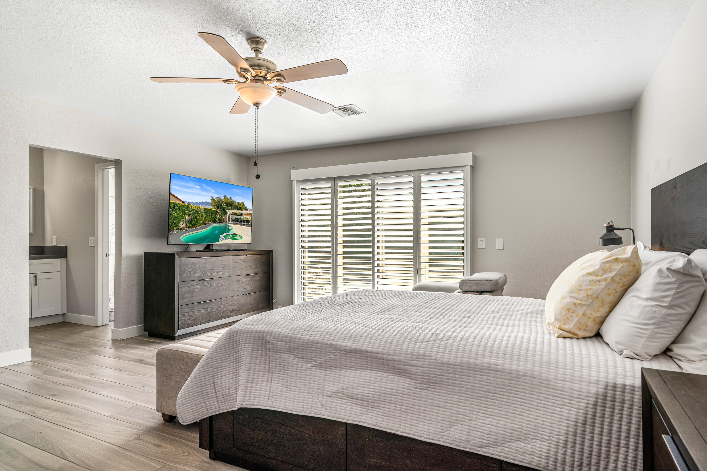 67265 Rango Road Cathedral City, CA 92234 - Photo 26 of 49 a bedroom with a bed and ceiling fan