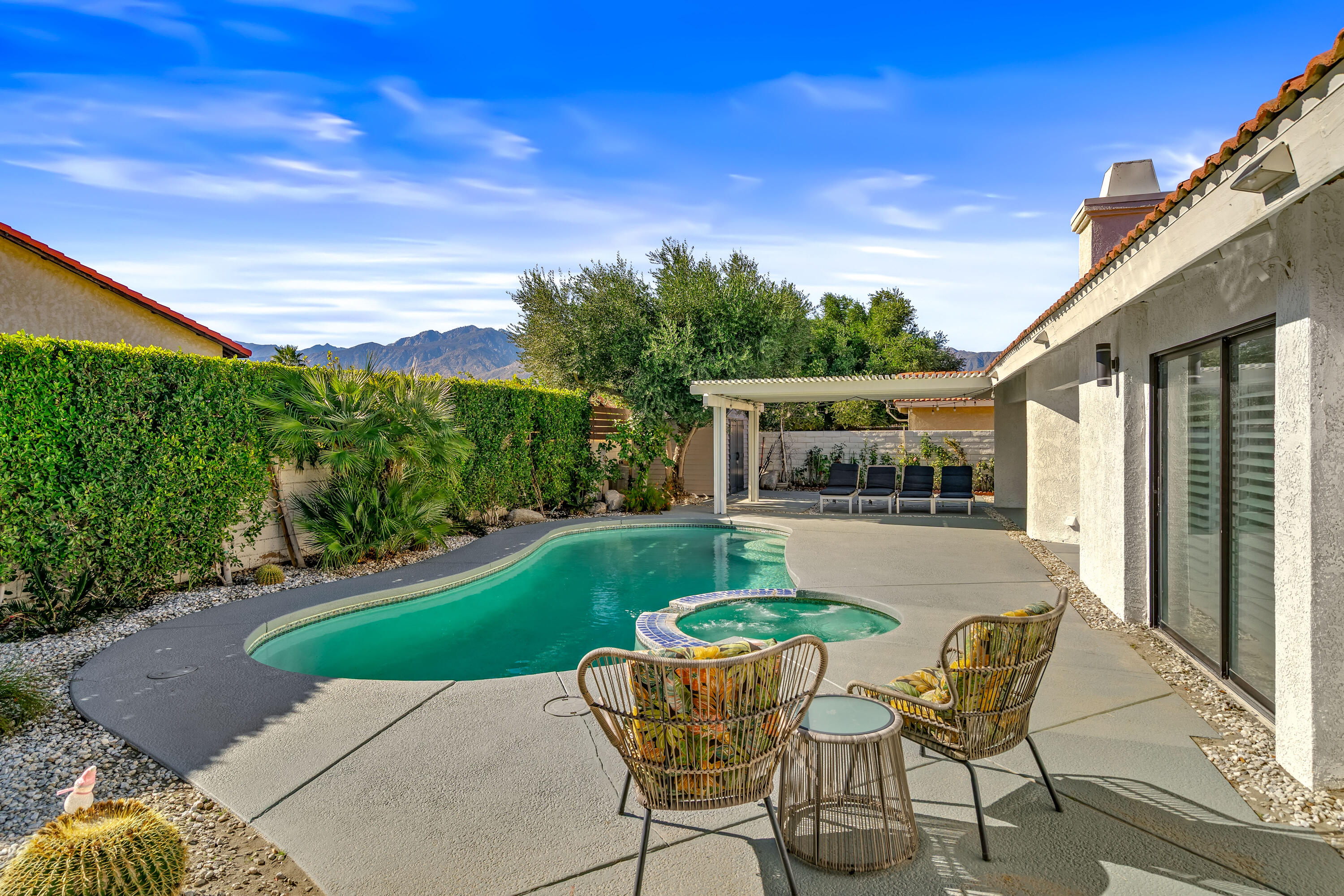 67265 Rango Road Cathedral City, CA 92234 - Photo 41 of 49 a patio with table and chairs and potted plants