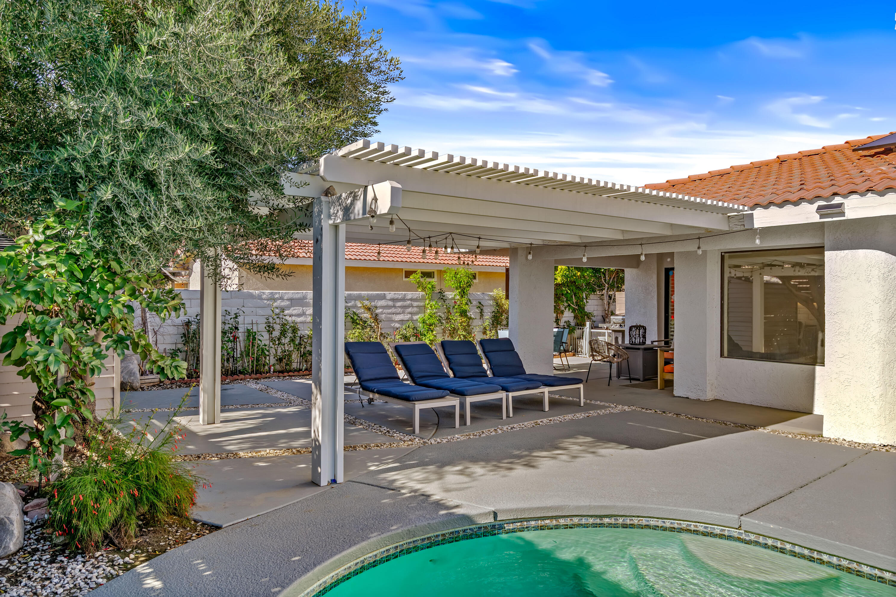 67265 Rango Road Cathedral City, CA 92234 - Photo 44 of 49 a view of a patio with table and chairs and potted plants