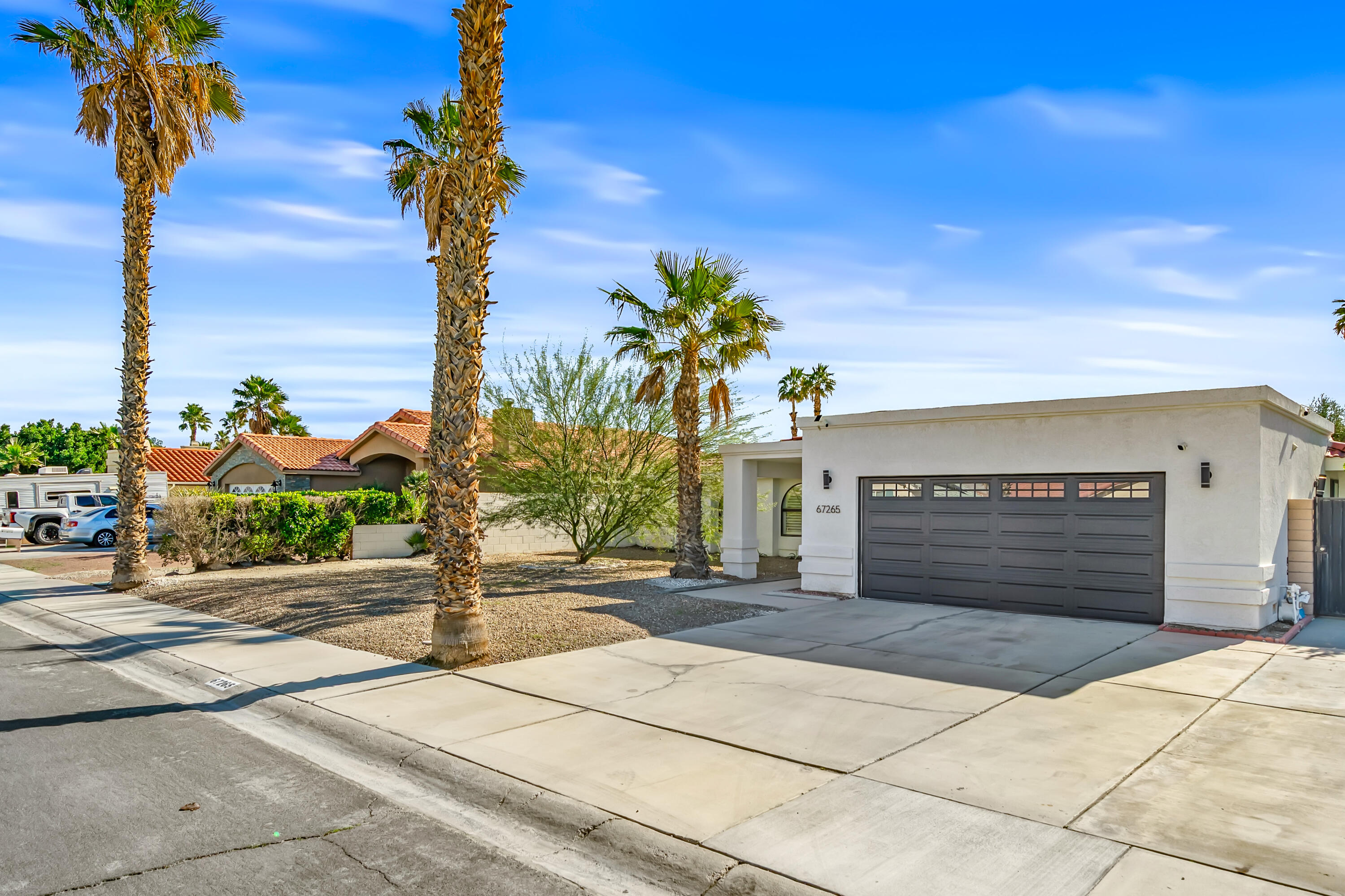 67265 Rango Road Cathedral City, CA 92234 - Photo 6 of 49 a front view of a house with yard and trees