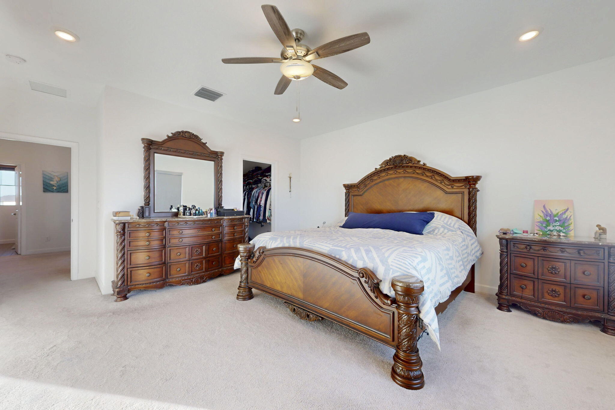1319 Arrowhead Point Road Loxahatchee, FL 33470 - Photo 13 of 45 a bedroom with a bed and dresser with mirror