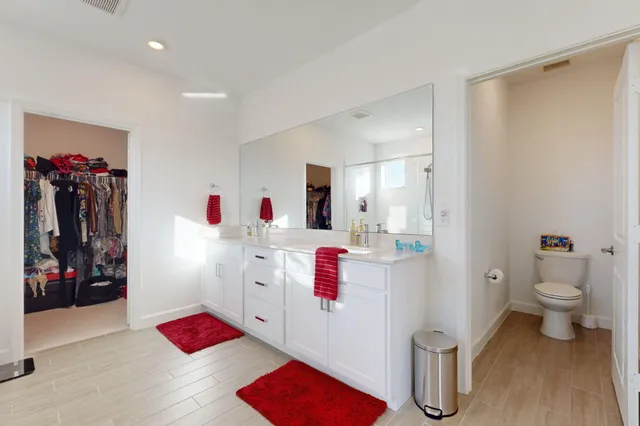 a bathroom with a toilet sink and mirror