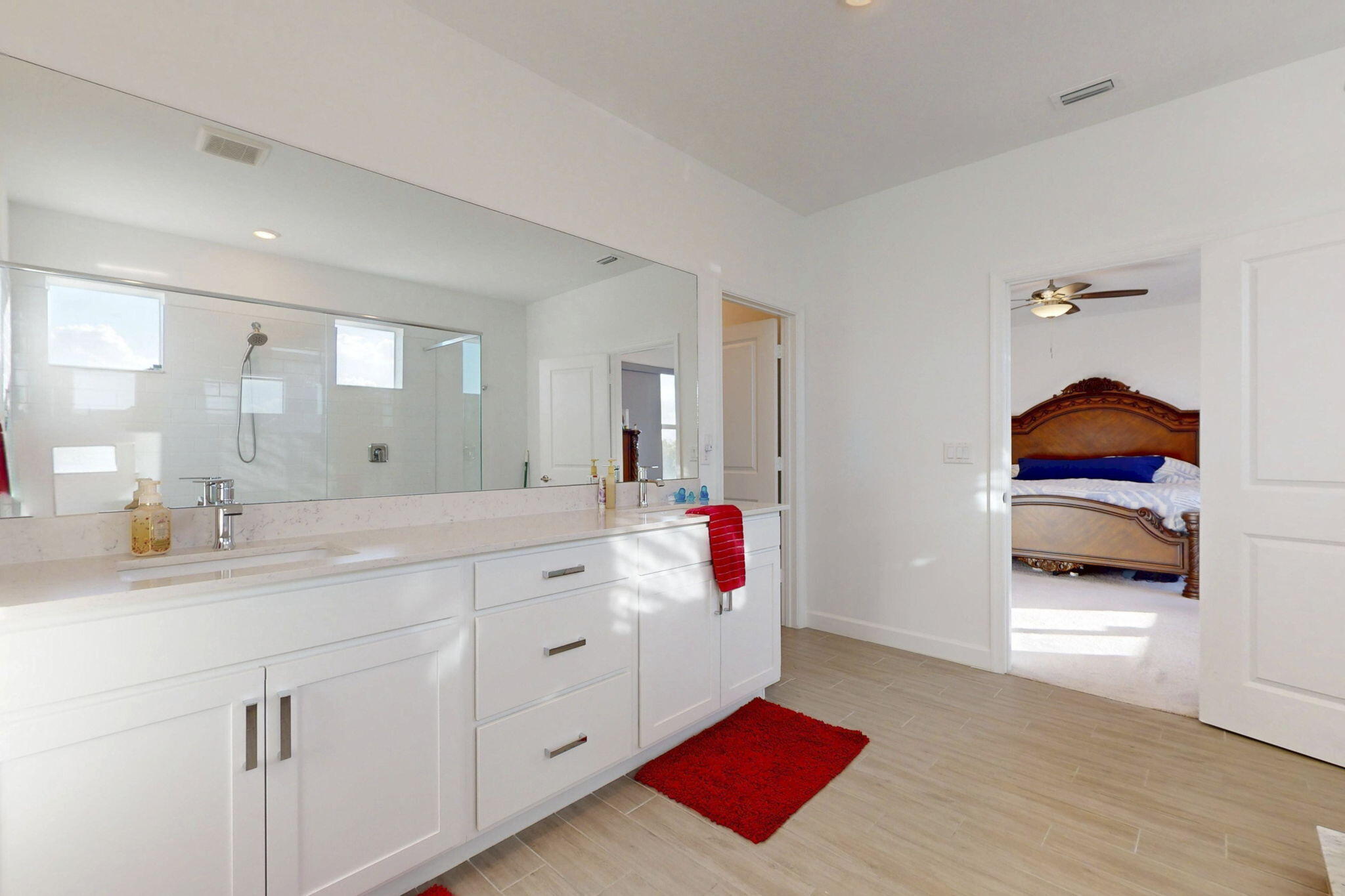 1319 Arrowhead Point Road Loxahatchee, FL 33470 - Photo 17 of 45 a en suite bathroom with a sink and a mirror