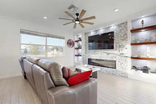 a living room with fireplace furniture and a flat screen tv