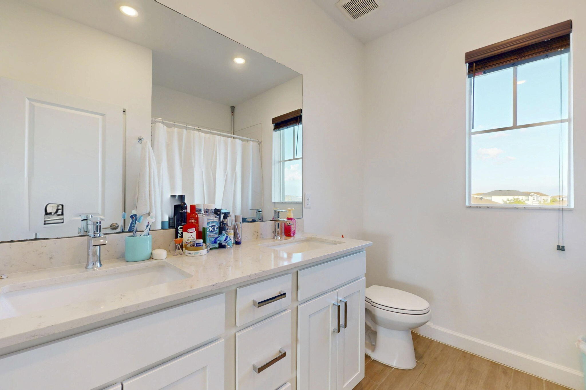 1319 Arrowhead Point Road Loxahatchee, FL 33470 - Photo 24 of 45 a bathroom with a toilet sink and mirror