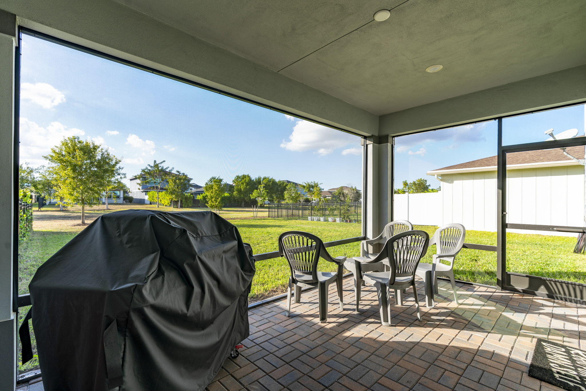 1319 Arrowhead Point Road Loxahatchee, FL 33470 - Photo 31 of 45 a view of a chairs and table in patio with a yard