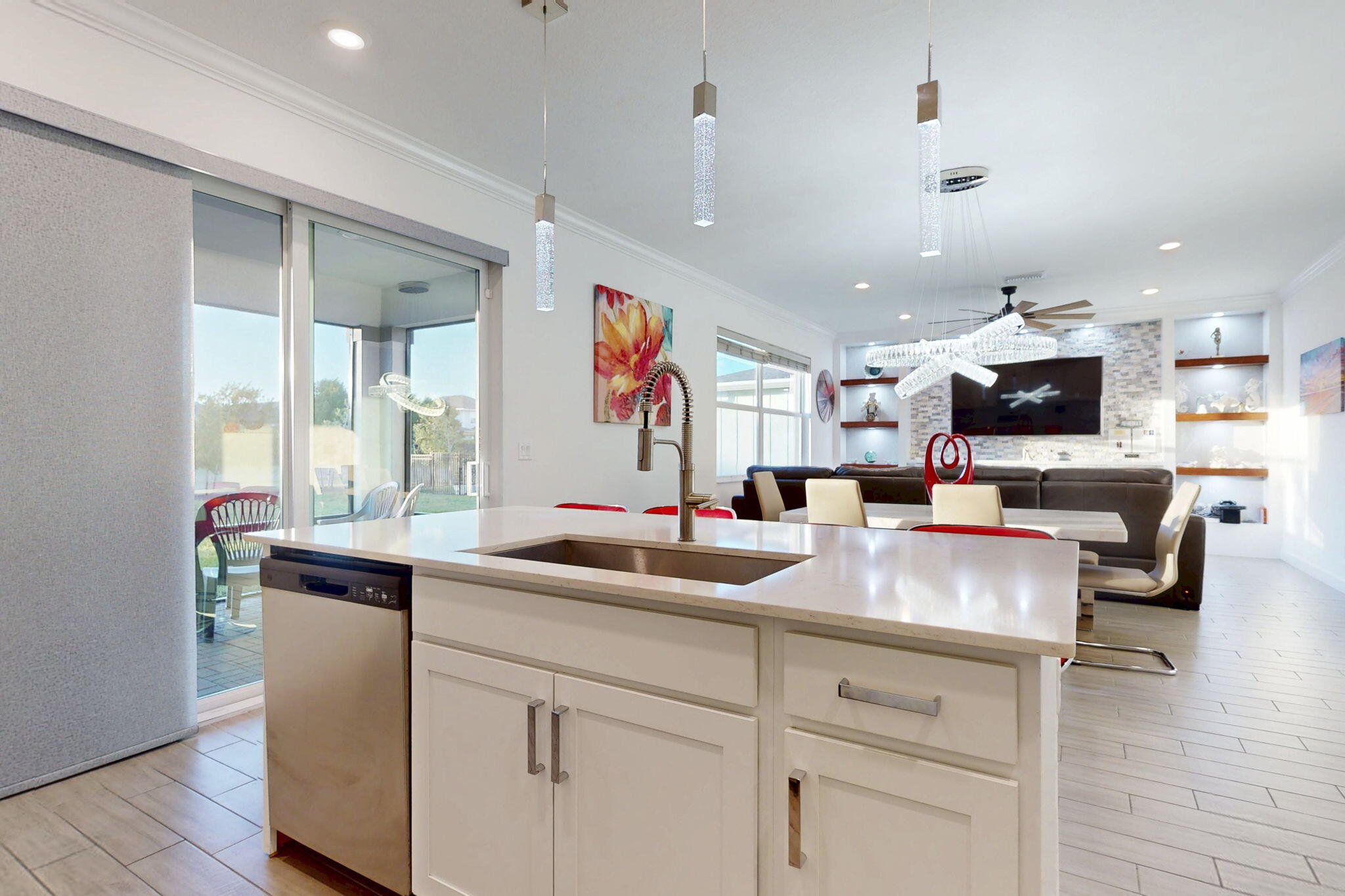 1319 Arrowhead Point Road Loxahatchee, FL 33470 - Photo 9 of 45 a kitchen with kitchen island granite countertop a sink and white cabinets with wooden floor