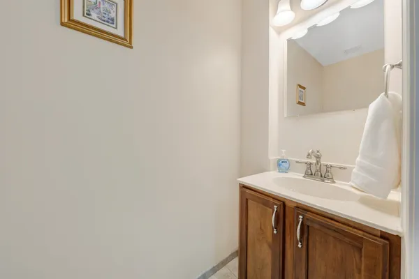 a bathroom with a sink vanity and a mirror