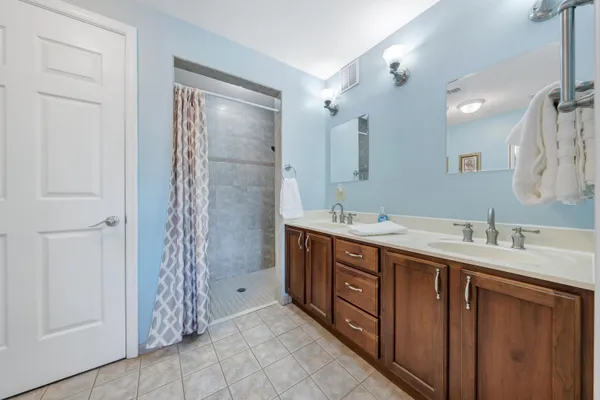 a spacious bathroom with double vanity sink and a mirror
