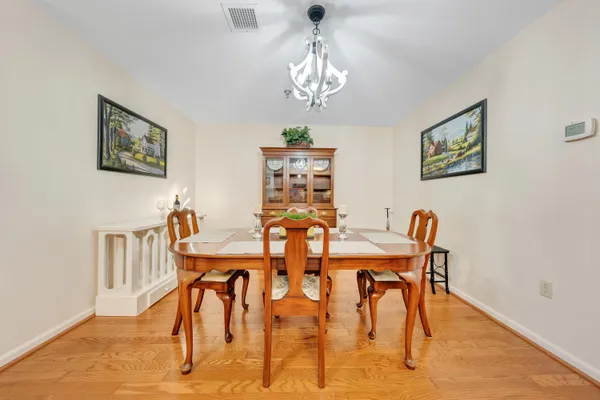 a view of a dining room with furniture and chandelier