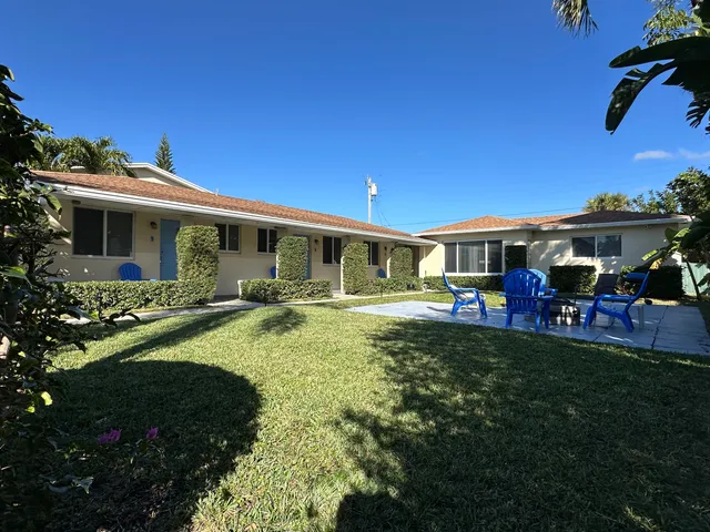 a view of a house with furniture and garden