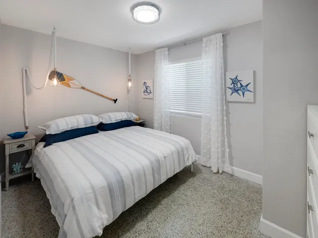 a bedroom with a bed and a painting