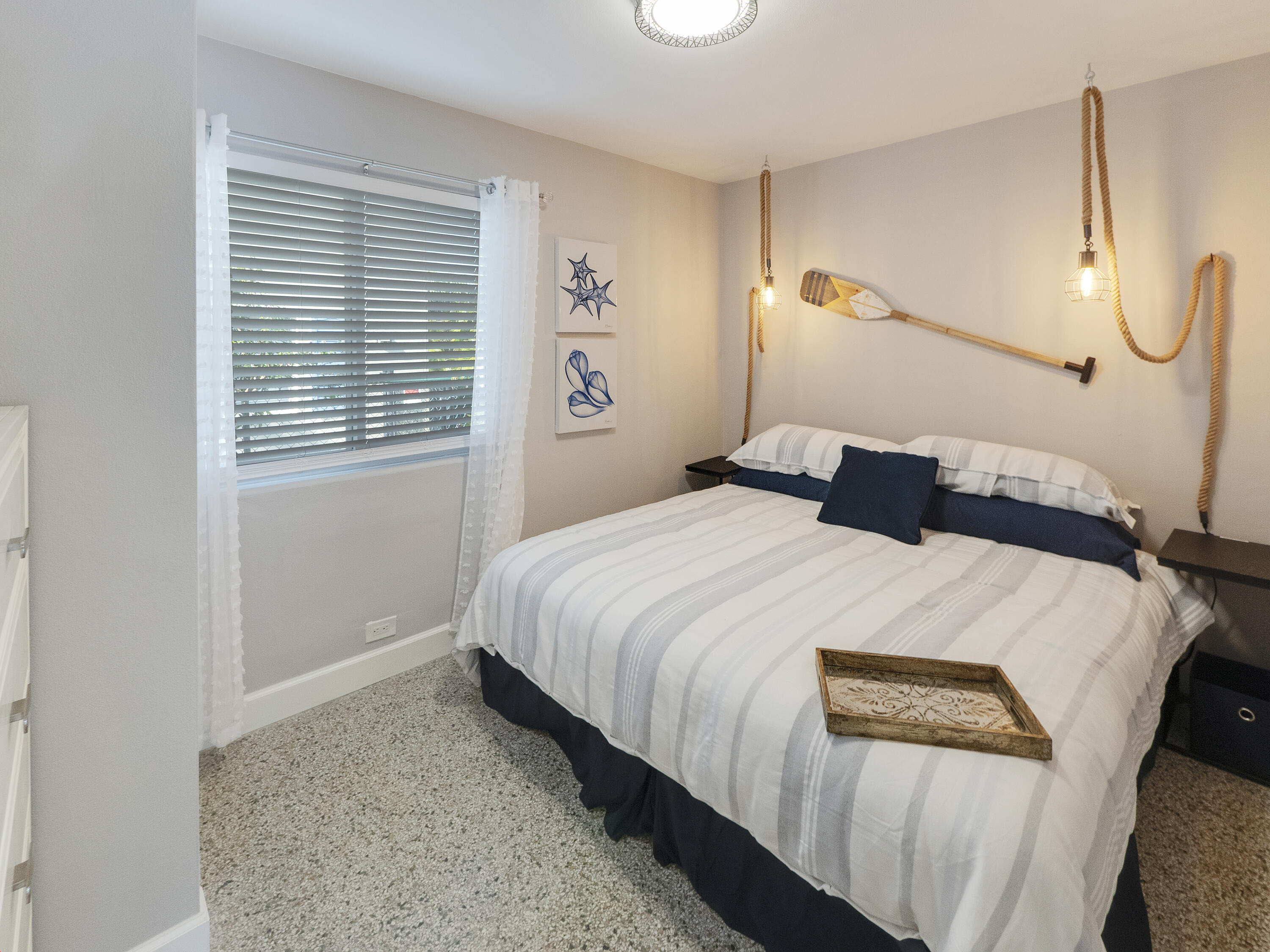 1258 Beach Road, Unit 7 Singer Island, FL 33404 - Photo 10 of 11 a bedroom with a bed and a window