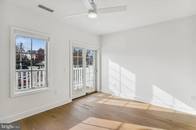 a view of an empty room with wooden floor