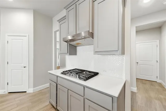 a kitchen with a stove and cabinets