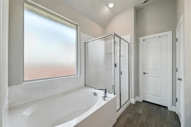 a bathroom with a bathtub and a shower