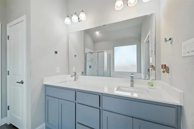 a bathroom with a sink a light fixture and a mirror