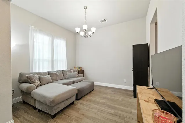 a living room with furniture wooden floor and a window