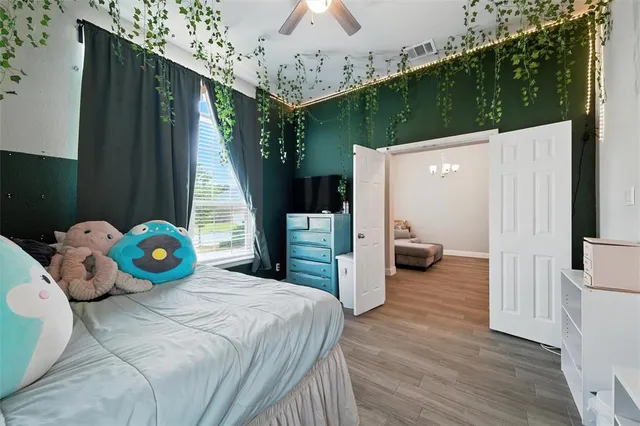 a bedroom with a bed and a chandelier