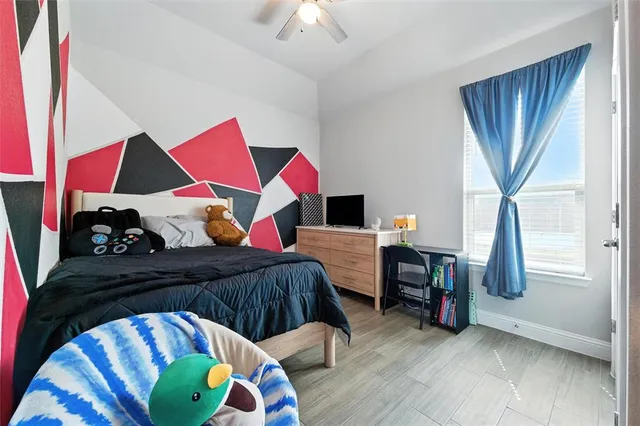 a bedroom with a bed and a chandelier